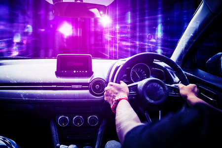 Rear view of young man driving a car game in the metaverse while sitting with infinity symbolの写真素材