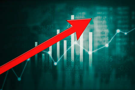Close up of red upward arrow with double exposure of growth diagram with stock market backgroundの写真素材