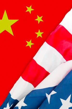 Close up of America and China flag on the table. Trade war concept