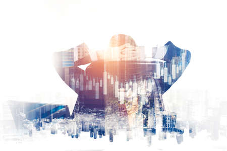 Double exposure of male manager sitting on the chair with growth candlesticks chart backgroundの写真素材