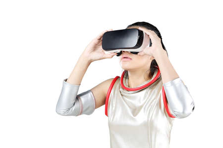 Female robot using VR goggles while standing in the studio. Isolated on white background