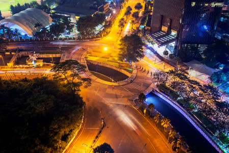 JAKARTA - Indonesia. May 09, 2022: Top down view of intersection road with glowing streetlight at night time in Jakarta cityのeditorial素材