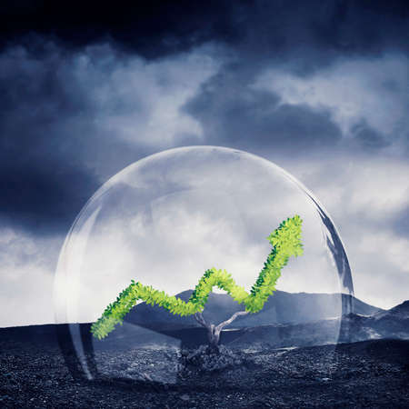 Close up of a green tree shaped upward arrow in bubble protection with cloudy sky backgroundの写真素材