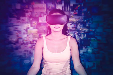 Young woman wearing VR goggles while meditating in the metaverse with binary code background