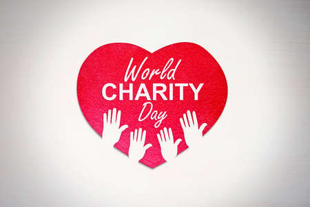 Red heart with hands symbol and world charity day text. Isolated on white backgroundの写真素材