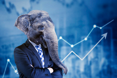Confident elephant-headed businessman with uptrend financial chart backgroundの写真素材