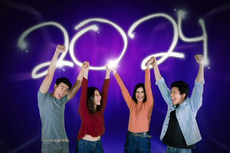 Happy group of young asian people dancing celebrating new year of 2024