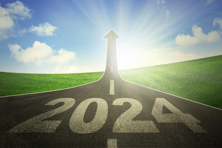 A road turning into an arrow rising upward symbolizing the direction to success in the year 2024