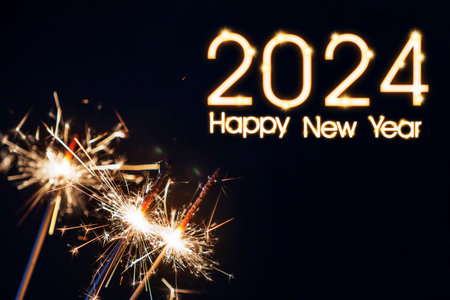 Close up of burning sparklers with numbers 2024 new year celebration