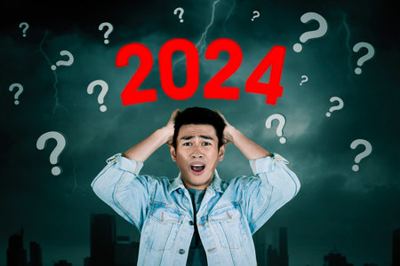 Panic male asian young entrepreneur with the new year 2024 uncertaintyの写真素材