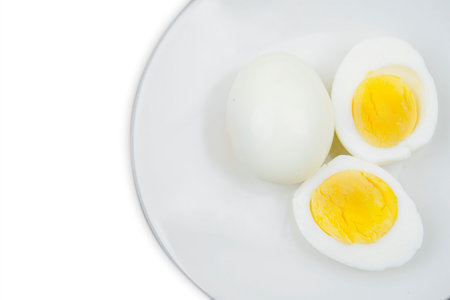 boiled egg on a plate over white backgroundの写真素材