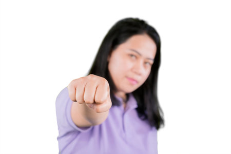 Portrait of a fat woman in sports wear hitting at camera with blurred face. shot with shallow depth of field. Isolated on a white backgroundの写真素材