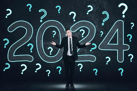Picture of confused businessman standing with question marks and number 2024 on the wall