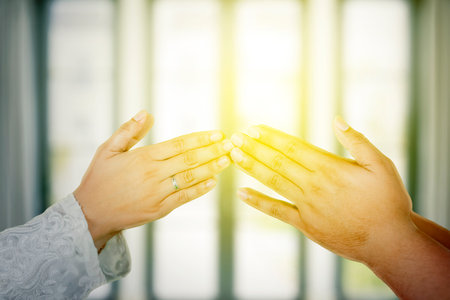 Male and female hands greeting one another on Ramadan Mubarak Holidayの写真素材