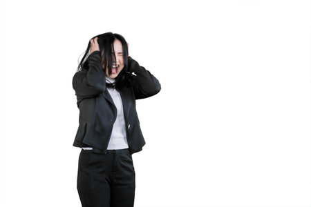 Stressed Businesswoman Holding Head in Frustration on White Backgroundの写真素材