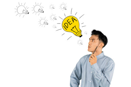 Creative Young Man Holding a Pen with Light Bulb Idea Concept Illustrationの写真素材
