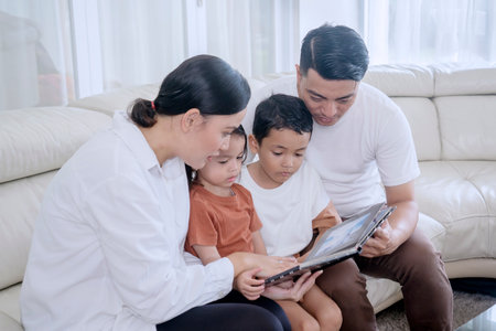 Loving Family Reading a Digital Book Together on a Tablet at Home