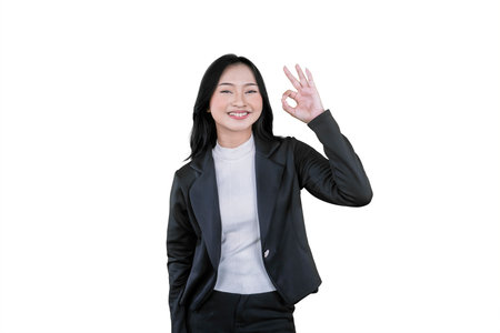 Confident Businesswoman Showing OK Hand Gesture with a Smile on White Backgroundの写真素材