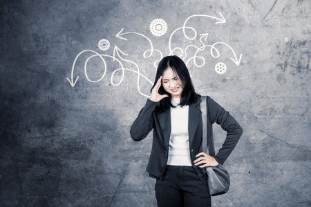 Stressed Businesswoman Holding Her Head with Confusion and Arrows Illustrationの写真素材