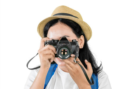 Young asian woman taking a photo with vintage camera isolated on white background