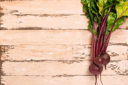 Fresh natural beets wooden background. Autumn summer harvest concept. Top view flat layout. Rustic...
