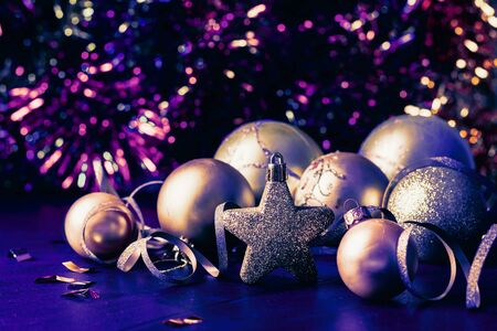 Traditional Christmas toys stars balls of gold color on a sparkling holiday background. New year christmas concept.の写真素材