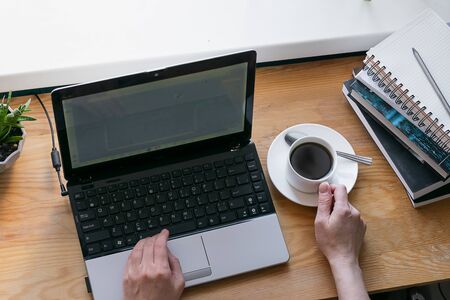 The concept of distance work or online learning during quarantine. Young woman works with laptop...