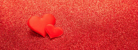 Two red heart symbol of love on a shiny background. Valentines day concept. Horizontal frame copy space.の写真素材