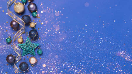 Christmas festive background with New Years toys balls stars sparkles. Template for a postcard with a bridge for text blue gold background, top view flat layoutの写真素材
