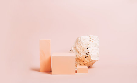 Modern abstract podium stone wooden geometric shapes pastel pink background. Copy space horizontal frame bannerの写真素材