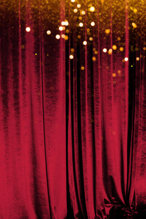 The red curtain made of luxurious velvet on the stage of the theater is fantastically glitteringの写真素材