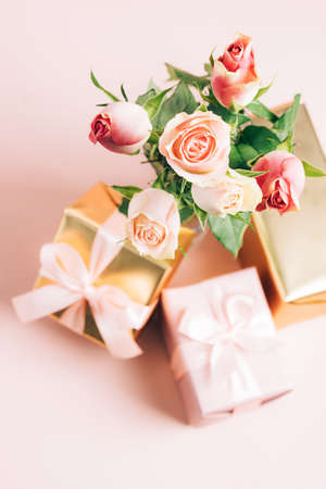 Beautiful fresh roses festive gift box on pastel pink background. Copy spaceの写真素材