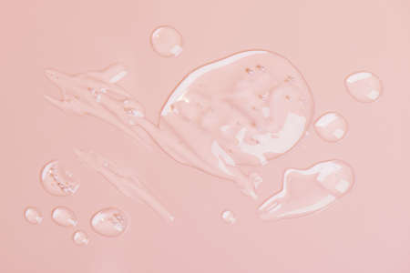 Cosmetic liquid gel serum lubricant hyaluronic acid with oxygen bubbles on a pink background. Facial body hair care.の写真素材