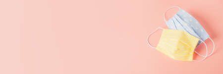 Eco-friendly reusable fabric safety mask on a pink background. Homemade breathing mask, protection...