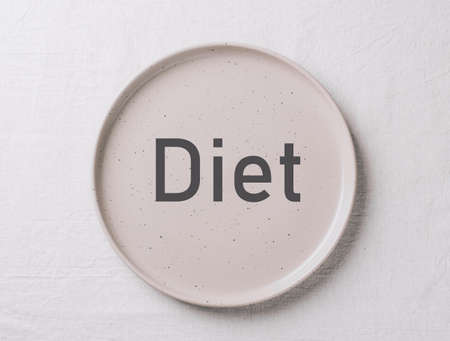 Empty ceramic shape plate for food on the table top view. Copy space