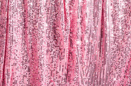 Fantastic background glitters pink curtain made of luxurious lurex sequins. Festive podium for party or Christmas.の写真素材