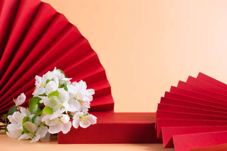 Abstract fashion podium for advertising cosmetics products. Red podium paper oriental fan pink pastel backgroundの写真素材