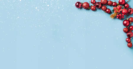 Christmas decorations red New Years balls on ablue background with snowflakes, sparkles, confetti....