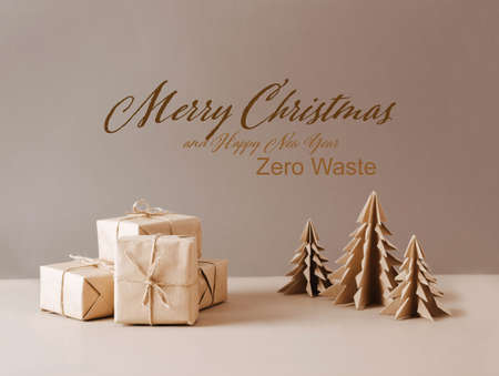 Christmas tree made of paper craft origami gifts packed in plain paper wooden star on a beige trendy...