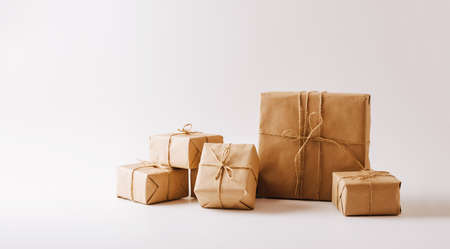 Gifts in eco-friendly paper packaging on a white background. Copy space concept minimalismの写真素材