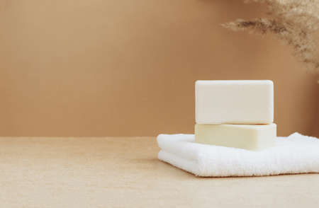 Bars of soap made from natural raw materials white soft towel beige background. Organic cosmetics. Spa health conceptの写真素材