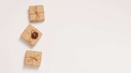 Festive background mockup for Christmas or New Year copy space. Gifts in paper eco-friendly packaging white backgroundの写真素材