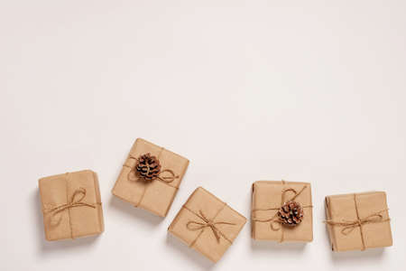 Festive background mockup for Christmas or New Year copy space. Gifts in paper eco-friendly...