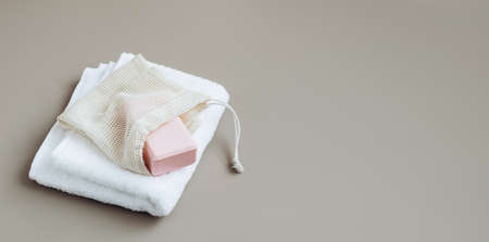 A bar of natural handmade soap lies on a soft white towel. Health beauty natural products concept. Organic natural cosmeticsの写真素材