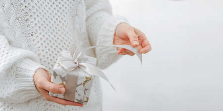 Female hands are holding small gift box. Winter holidays concept New Year Christmas. Selective...