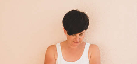 Portrait of a middle-aged woman in casual clothes without makeup, positive emotions. Feminine...