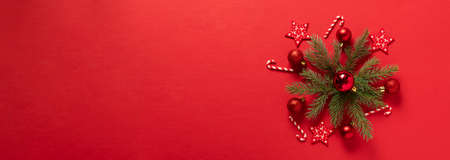 Fluffy branches of fir-tree Christmas toys red shiny balls laid out in the form of snowflakes,...