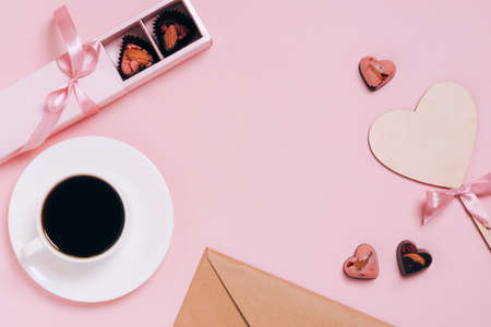 Chocolates festive box cup of coffee, hearts, an envelope pink background. Festive composition for Valentines Dayの写真素材