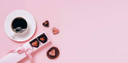 Chocolate candies hearts festive box coffee cup pink background, copy space. Holiday concept February 14 Valentines Dayの写真素材