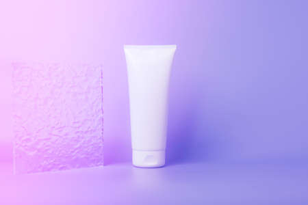 Cosmetic product in a tube, white container purple background. Shampoo, hand cream, toothpaste white...